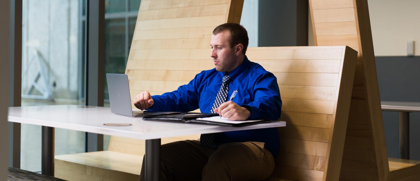 Student typing on laptop in the Engineering Center